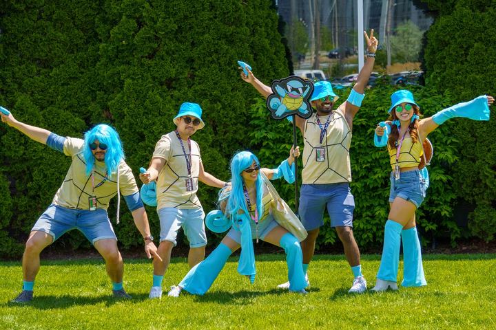 Cosplayers striking a group pose on the grass at Anime North