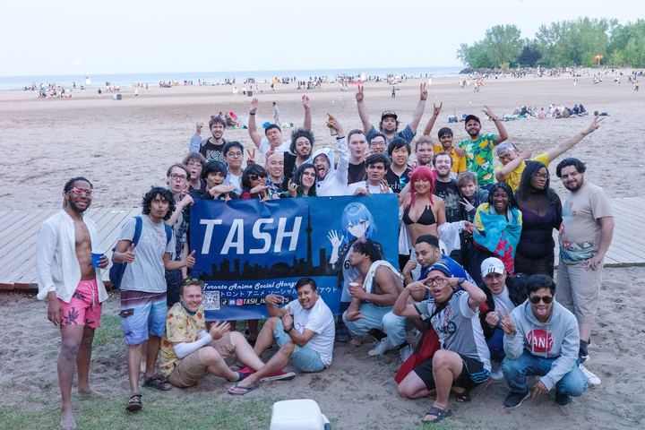 TASH members with the group's banner on a Toronto beach