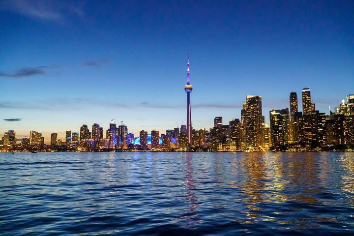 Toronto's skyline lit up at dusk from the Toronto Islands