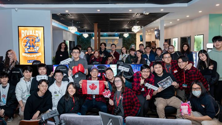 A packed room at a Toronto TFT LAN in May 2024, some holding Canadian flags