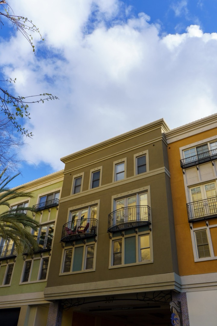 A yellow apartment building against a blue sky