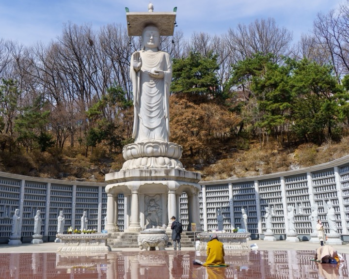 A giant standing Buddha statue at a temple