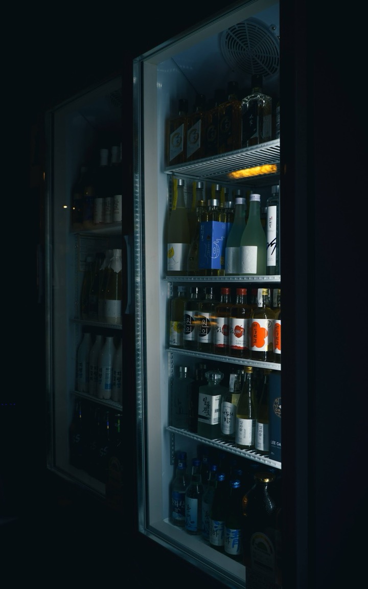A glowing drinks vending machine in the dark