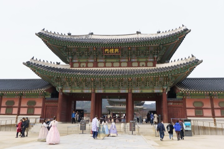 A palace gate in Seoul, with visitors in hanbok