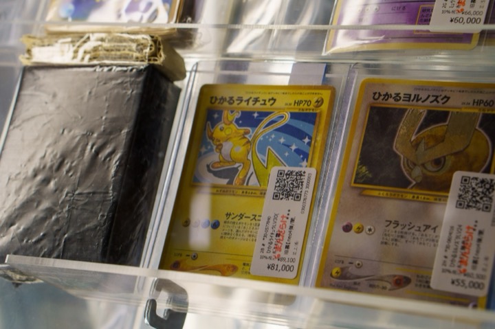 Graded Pokémon cards in a display case