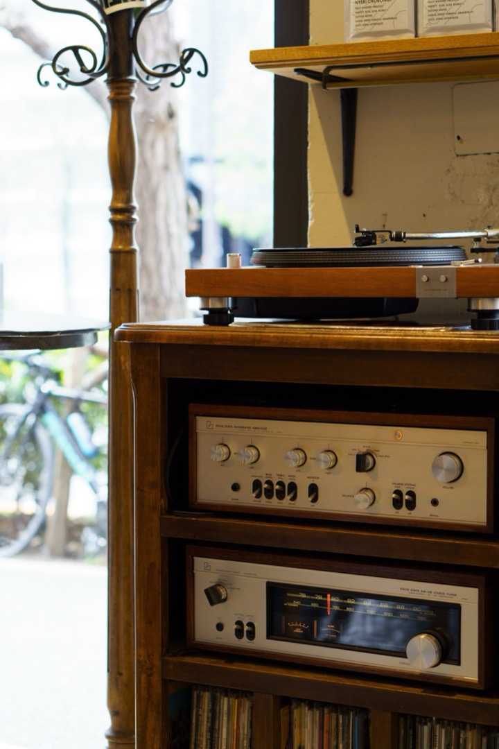 A vintage stereo amplifier on a wooden cabinet