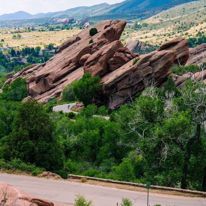 Red sandstone slabs above green trees at Red Rocks