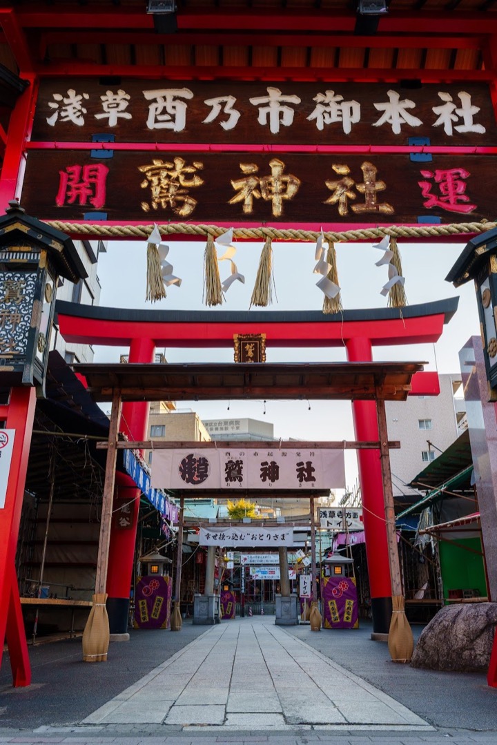 A red shrine gate hung with lanterns on a street in Asakusa